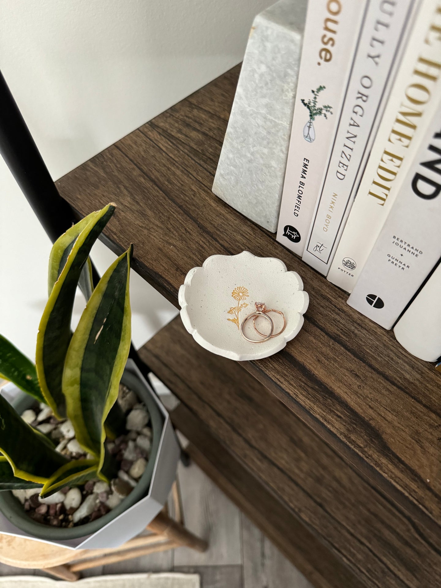 white clay royal edge shaped ring dish with gold daisy design in center